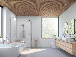 spacious lit white washroom containing two sinks
