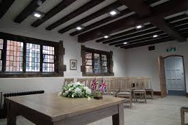 Elegant dining room with a wooden table, upholstered chairs and roof lights