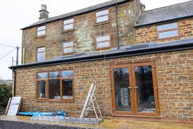 side view of a house displaying a white ladder